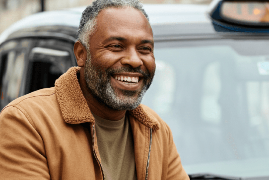 Taxi driver outside black cab