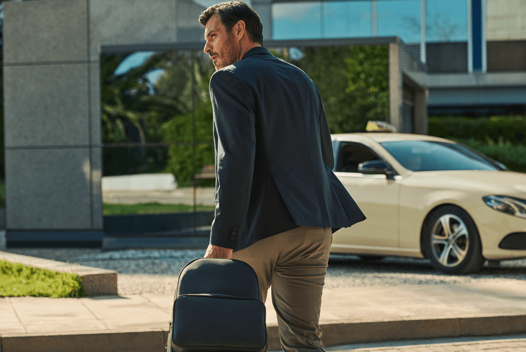 Woman rushing in the street to taxi with red luggage