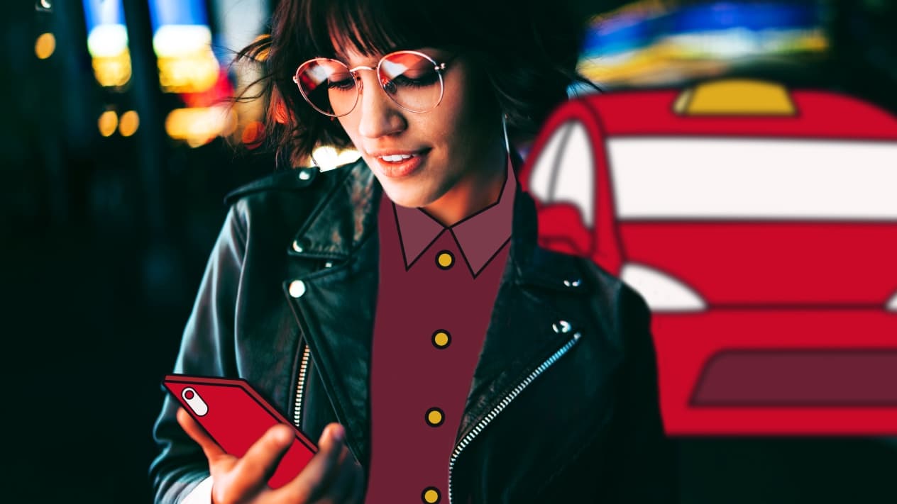 woman outside holding and looking at mobile