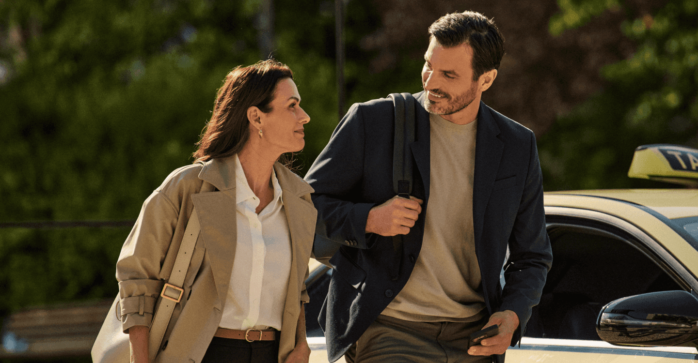 two people walking outside and smiling