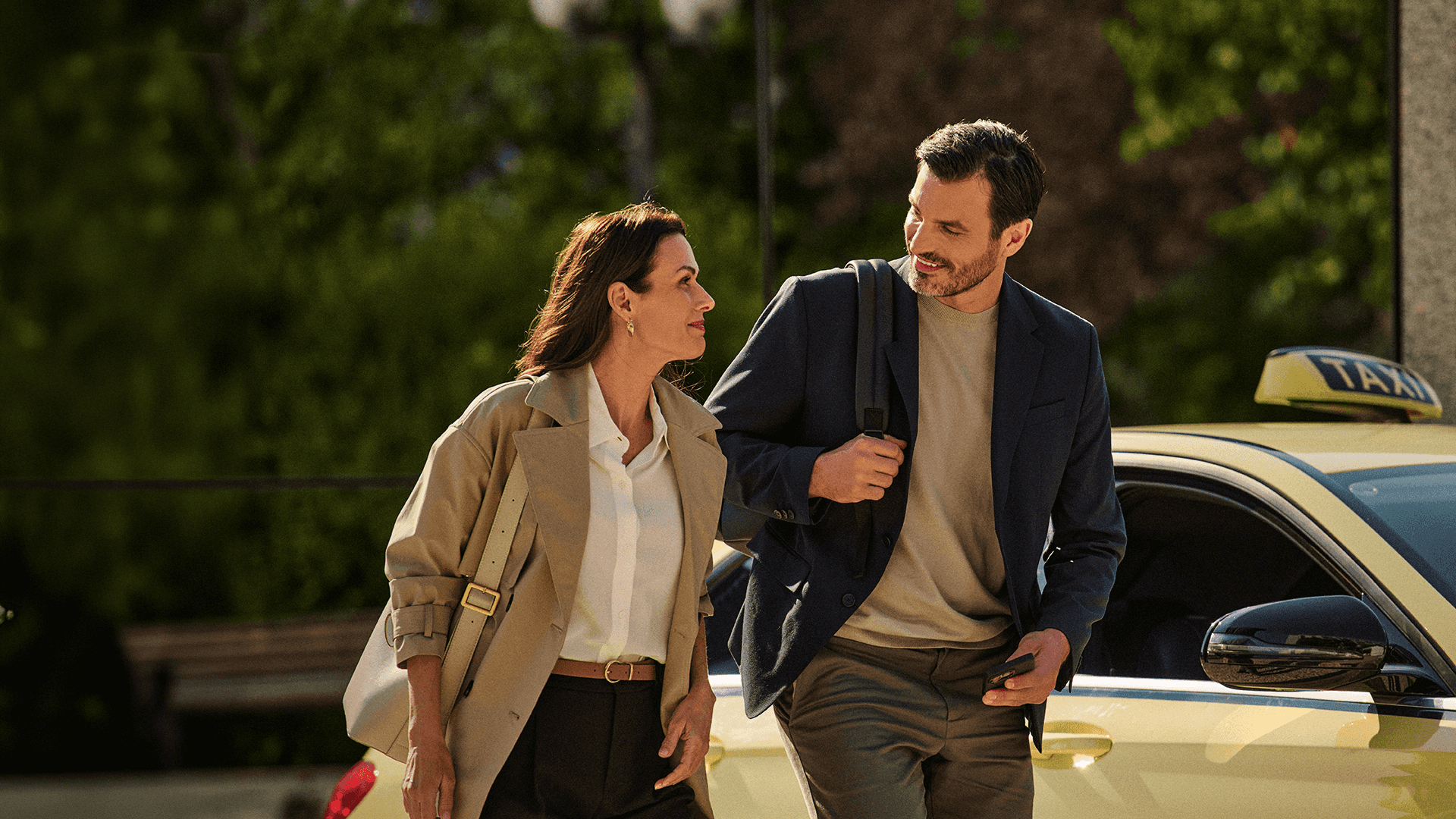 two people walking outside and smiling