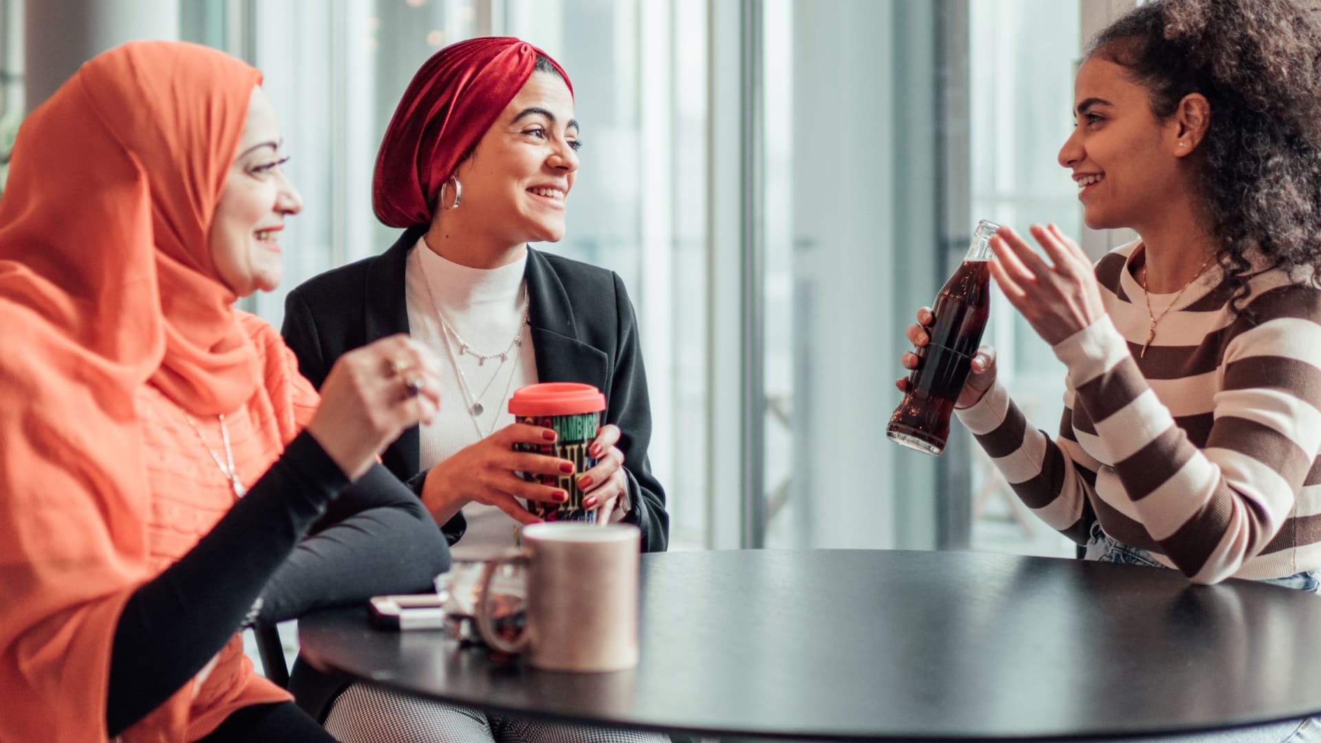 three women sitting at office table