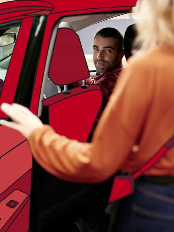 Driver looking as a passenger steps into the car