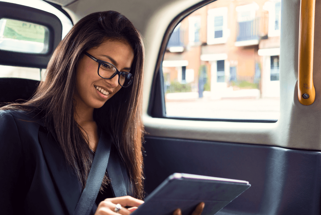 business travel inside Freenow taxi looking at tablet