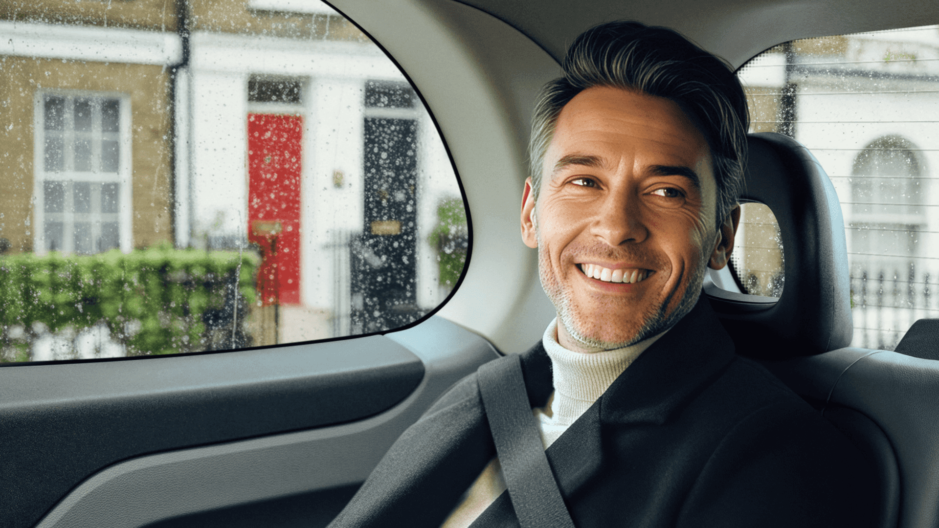 man sitting in the back of a black cab