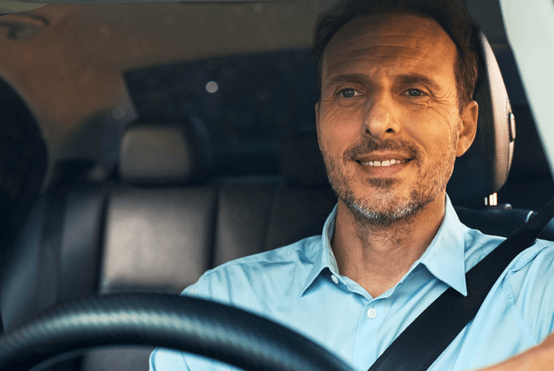 FREENOW taxi driver driving in the rain safely going to pick up employee after corporate event