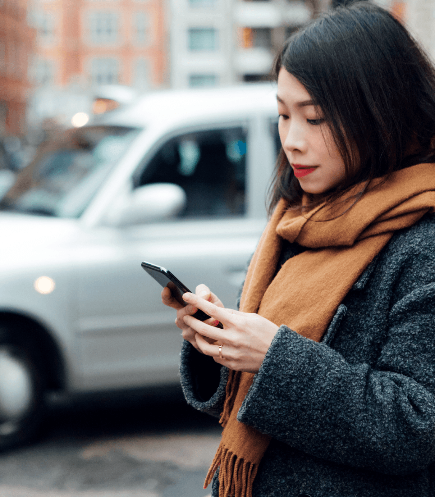 woman on the street looking at phone