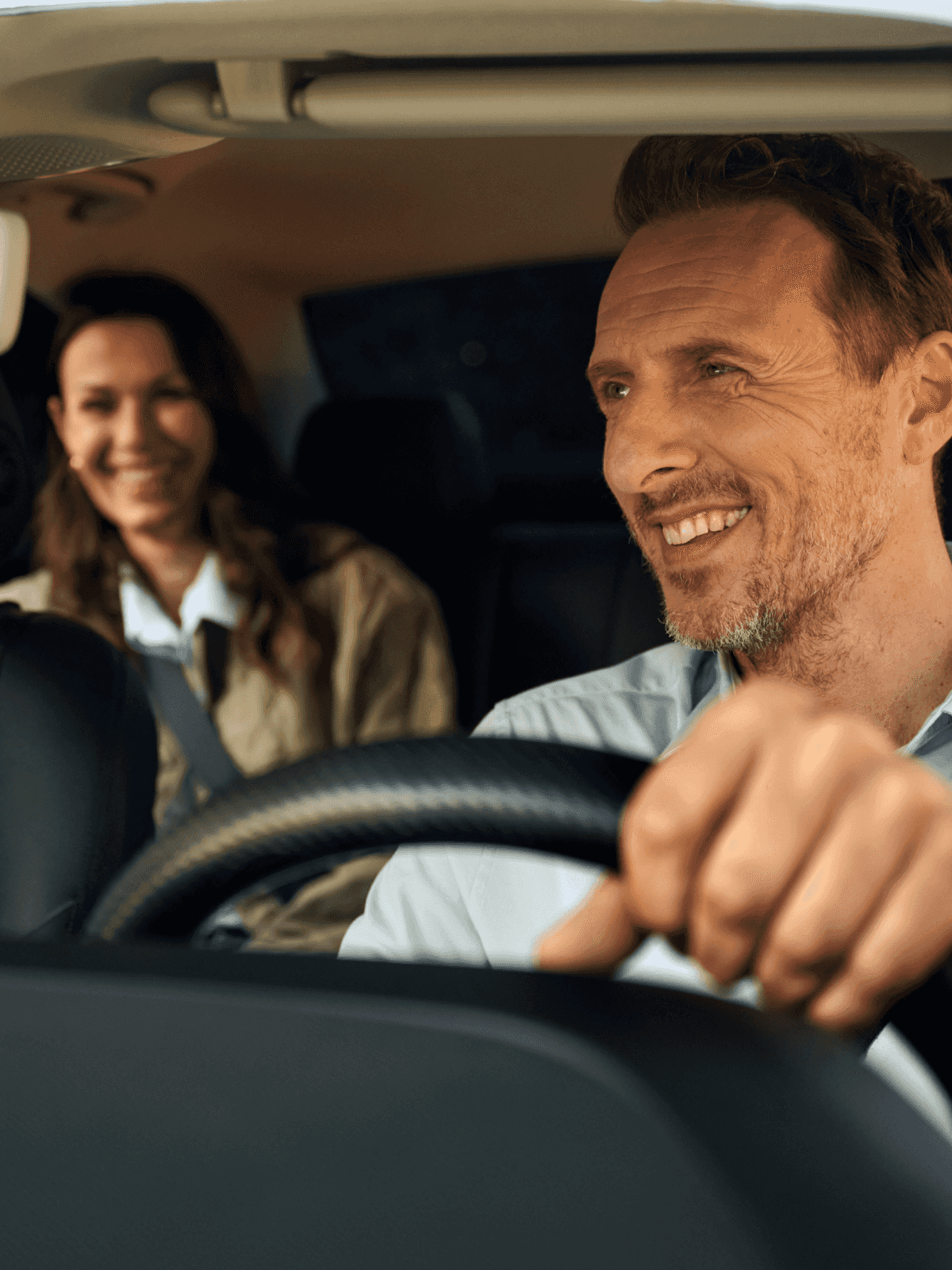 Freenow taxi driver and passenger smiling in taxi