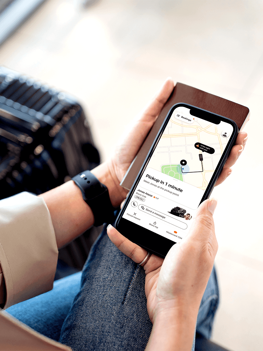 Employee getting into FREENOW Airport Transfer outside an airport