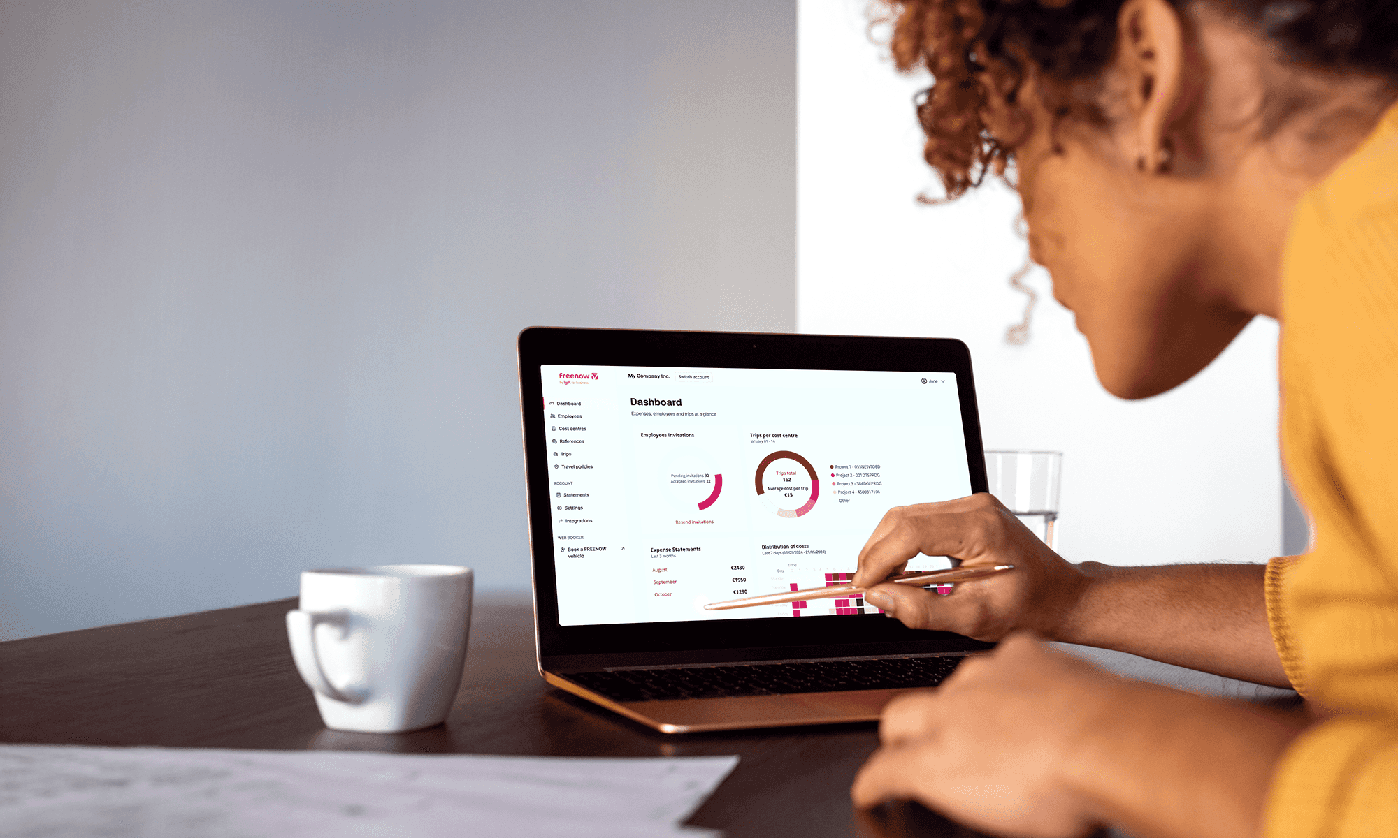 Woman on laptop using FREENOW business travel software